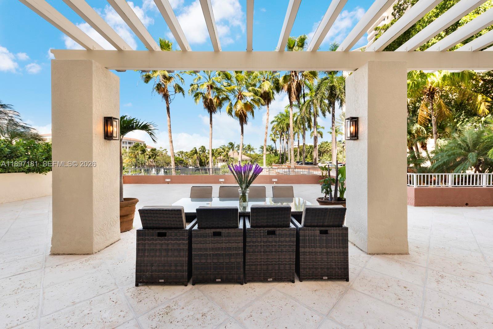 765 Crandon Boulevard, Unit 102 Key Biscayne, FL 33149 - Photo 6 of 37 a room with furniture and a potted plant