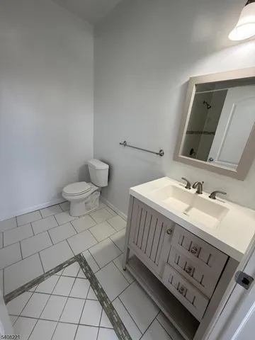 a bathroom with a sink a toilet and mirror