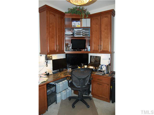 3733 Old Post Road Raleigh, NC 27612 - Photo 12 of 25 First Floor Office w/double door access, carpet, light fixture, 3 double windows w/2" faux Plantation blinds, & upgraded w/desk, shelving, & drawers w/framed cabinetry & counter top! Studio/Study/Office
