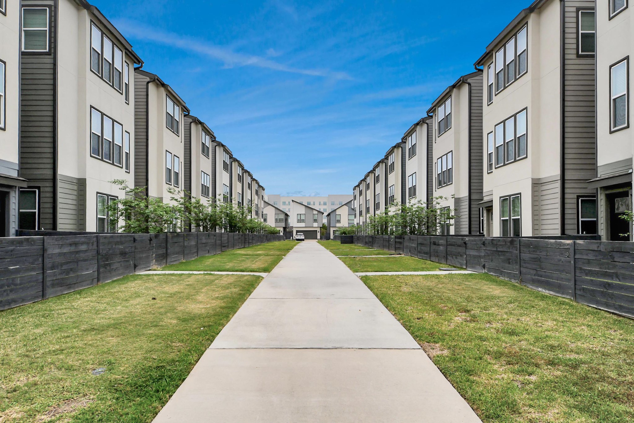 18527 Centro Row Conroe, TX 77385 - Photo 40 of 44 Manicured turf flanks the community walkways, creating a park-like corridor that encourages strolls through the neighborhood’s open spaces.