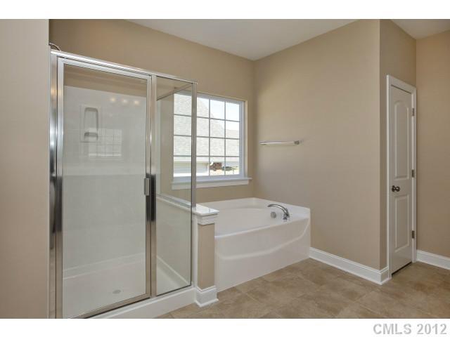 86587 Arrington Road, Unit 101 Lancaster, SC 29720 - Photo 13 of 16 a bathroom with a bathtub and a shower