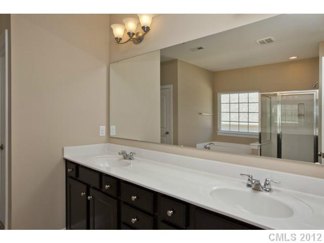 86587 Arrington Road, Unit 101 Lancaster, SC 29720 - Photo 14 of 16 a bathroom with a sink vanity and a mirror