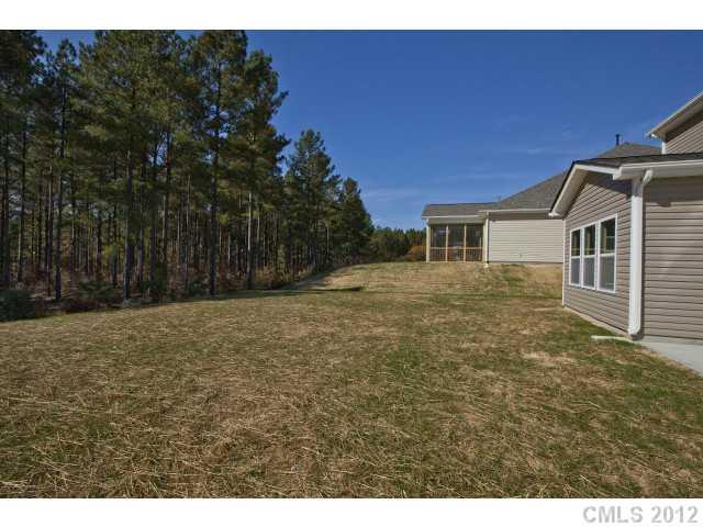 86587 Arrington Road, Unit 101 Lancaster, SC 29720 - Photo 15 of 16 a backyard of a house with large trees