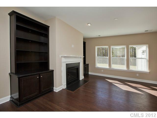 86587 Arrington Road, Unit 101 Lancaster, SC 29720 - Photo 7 of 16 a view of an empty room with a fireplace and a window