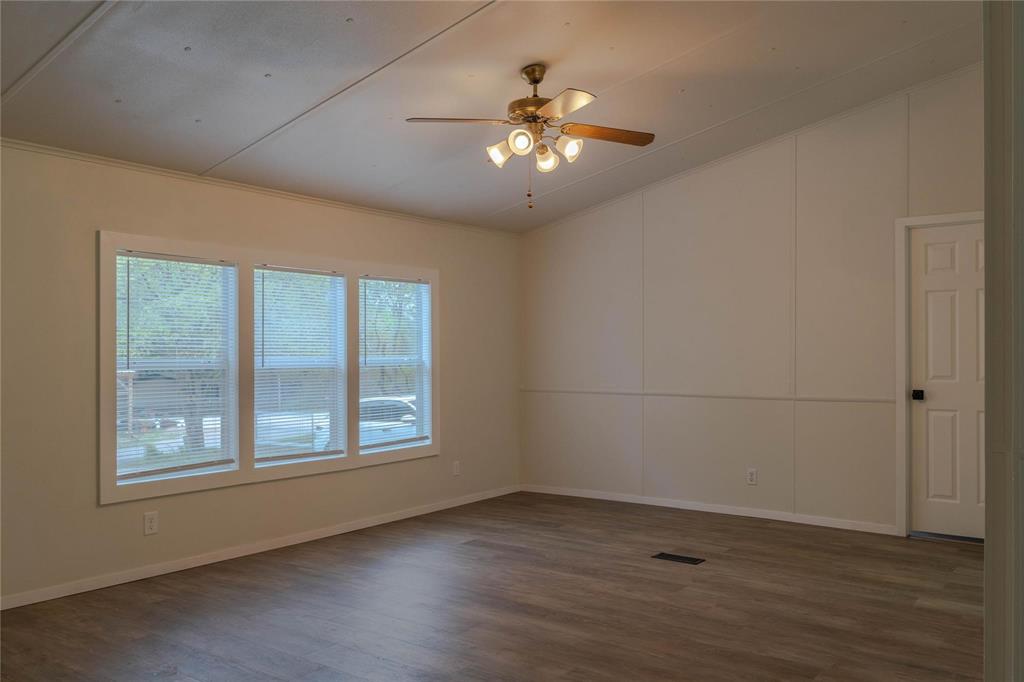 4817 Creekside Road Melissa, TX 75454 - Photo 2 of 10 an empty room with wooden floor and windows