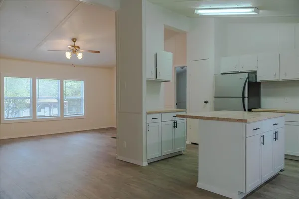 a kitchen with kitchen island a sink stainless steel appliances and cabinets