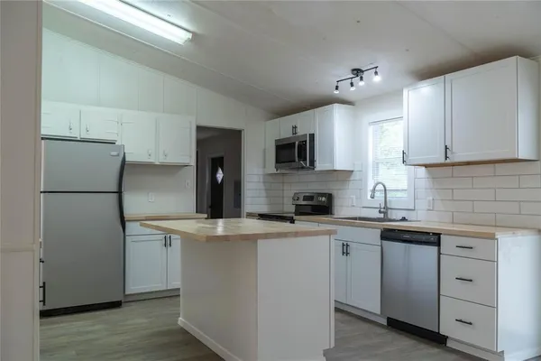 a kitchen with a sink stove and refrigerator