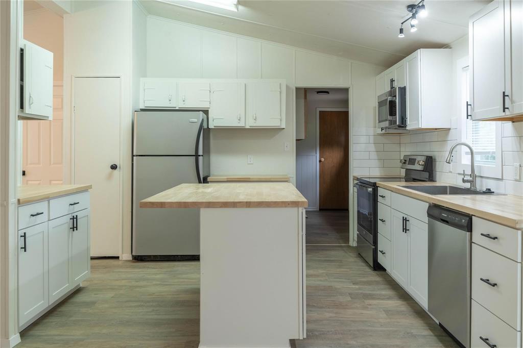 4817 Creekside Road Melissa, TX 75454 - Photo 5 of 10 a kitchen with a sink stove and refrigerator