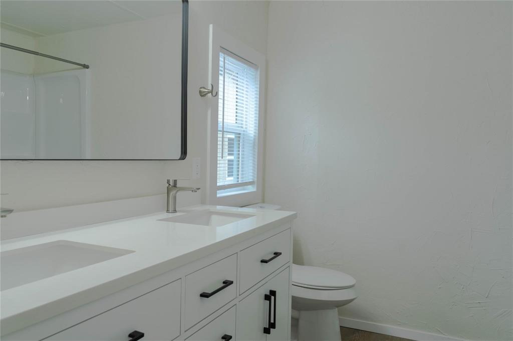 4817 Creekside Road Melissa, TX 75454 - Photo 9 of 10 a bathroom with a sink a toilet and a mirror