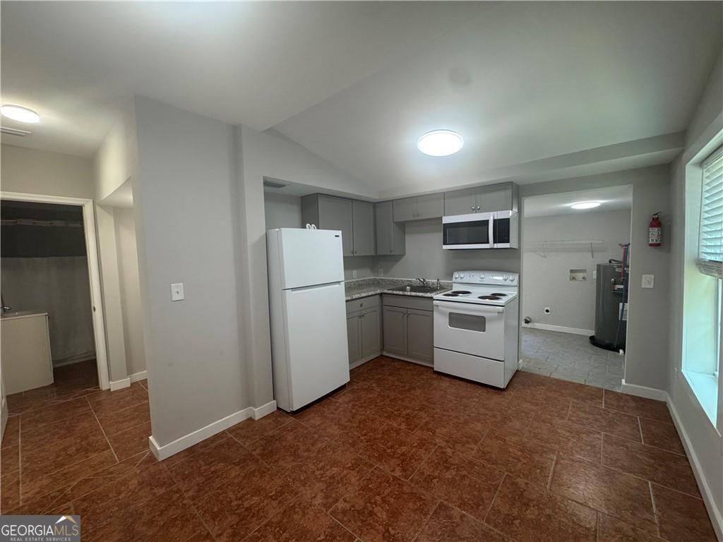 801 R Street Brunswick, GA 31520 - Photo 20 of 26 a kitchen with white cabinets and white appliances