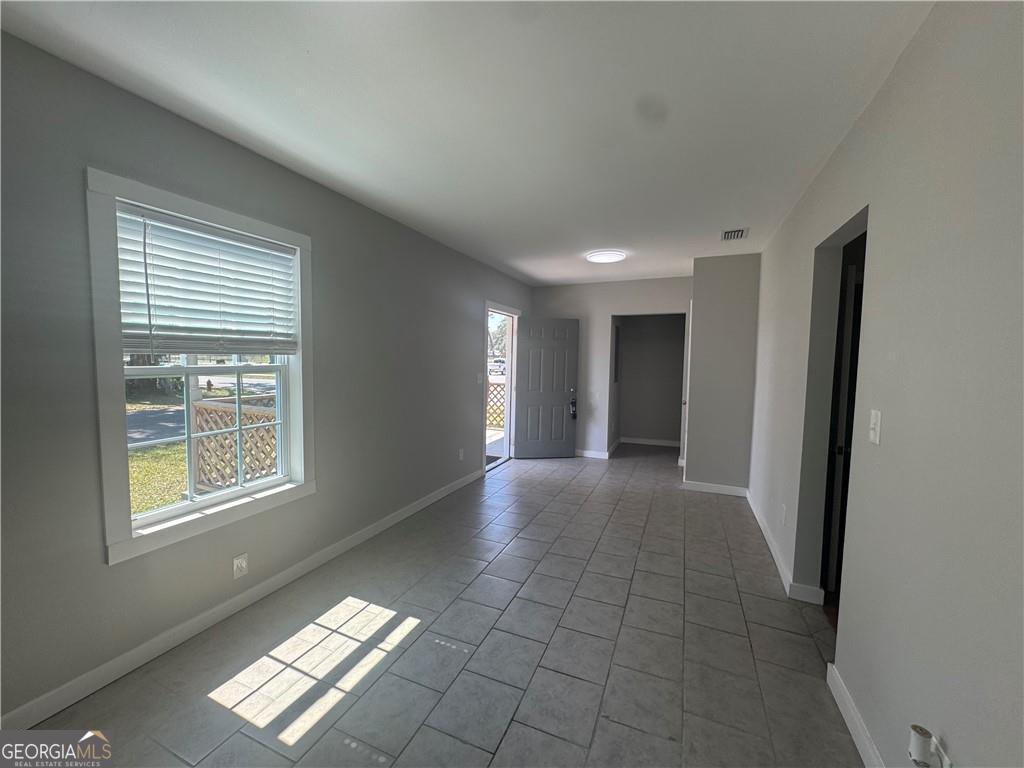 801 R Street Brunswick, GA 31520 - Photo 5 of 26 a view of an empty room with a window