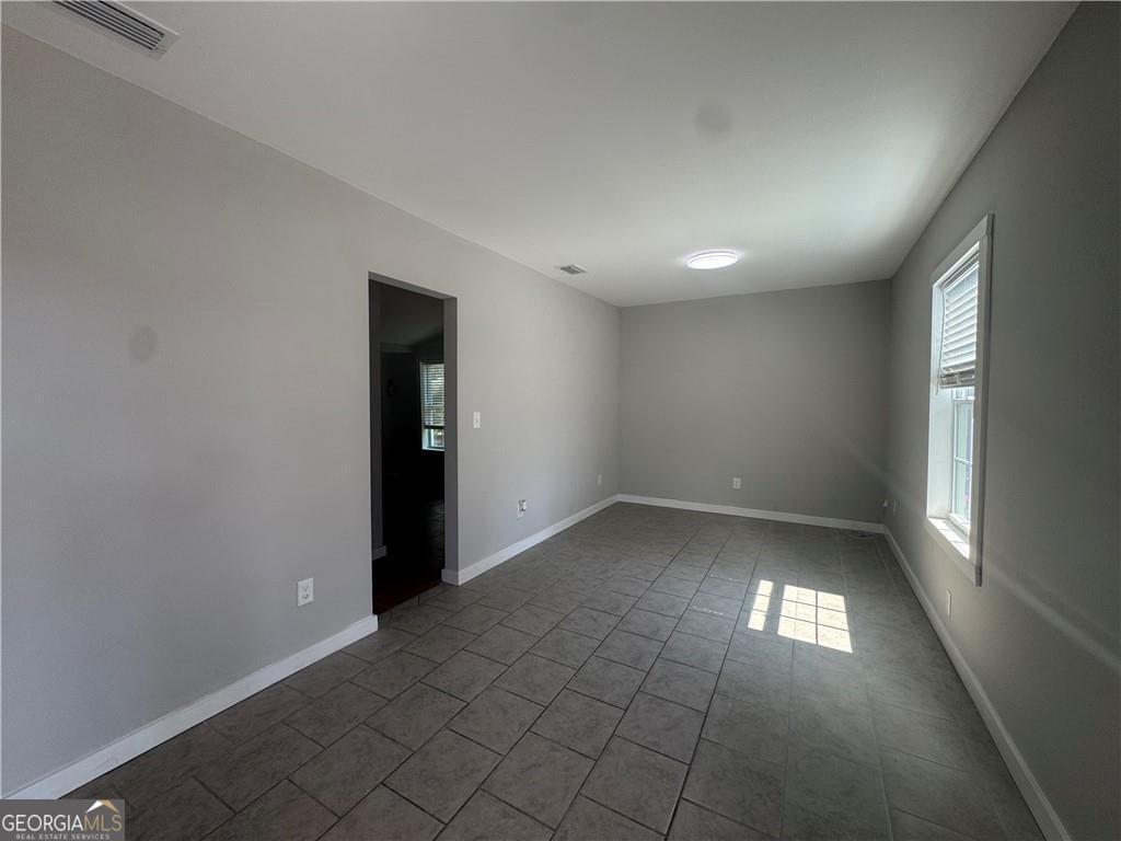801 R Street Brunswick, GA 31520 - Photo 7 of 26 an empty room with a empty space and windows
