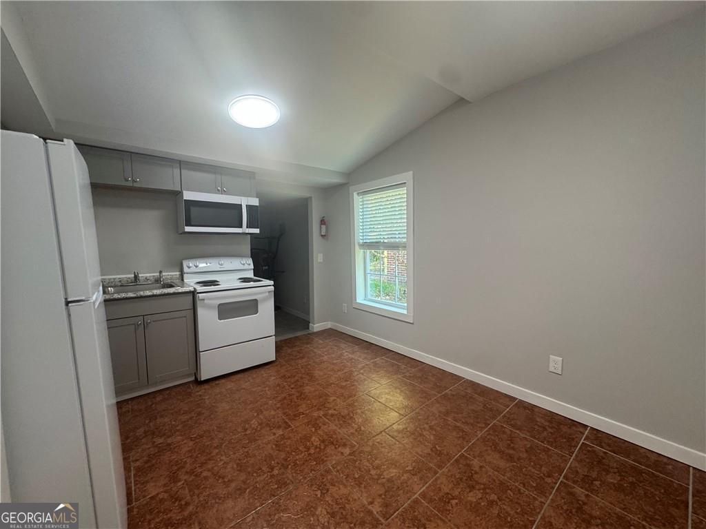 801 R Street Brunswick, GA 31520 - Photo 8 of 26 a kitchen with a refrigerator stove and sink
