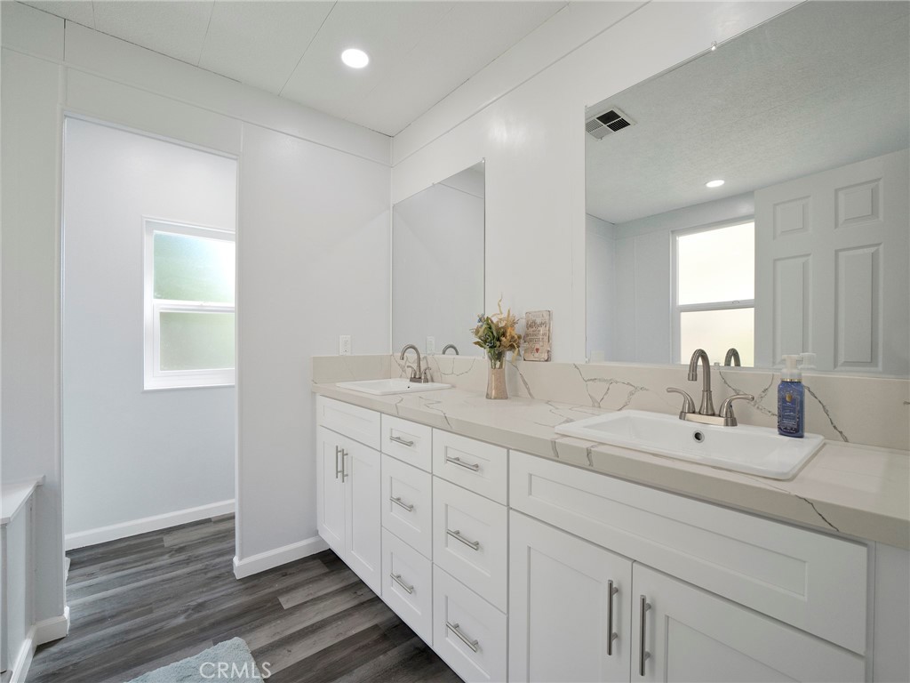 24303 Woolsey Canyon Road, Unit 85 West Hills, CA 91304 - Photo 13 of 31 a spacious bathroom with double sink a mirror and a window