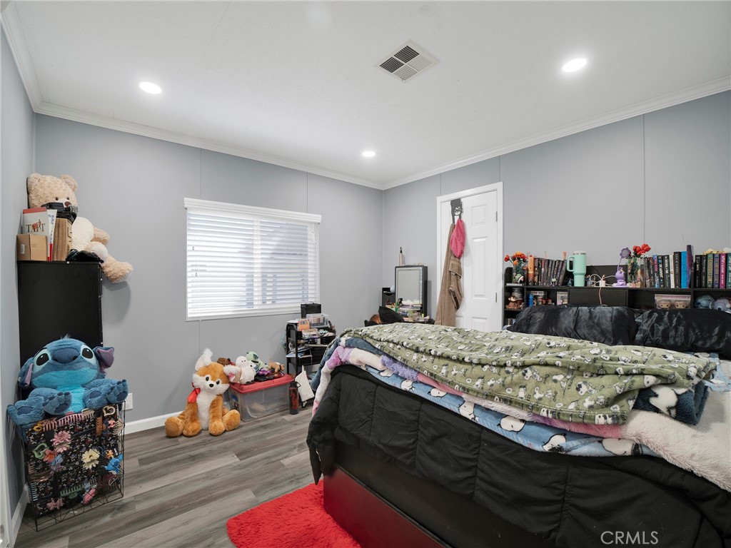24303 Woolsey Canyon Road, Unit 85 West Hills, CA 91304 - Photo 16 of 31 a bed room with a bed furniture and a flat screen tv