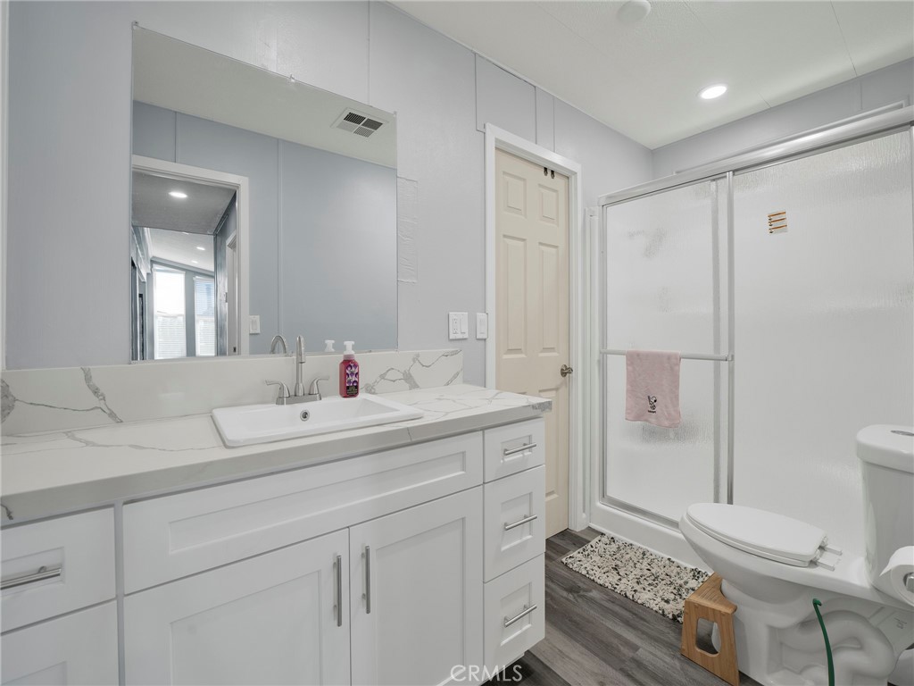 24303 Woolsey Canyon Road, Unit 85 West Hills, CA 91304 - Photo 18 of 31 a en suite bathroom with a double vanity sink toilet and shower