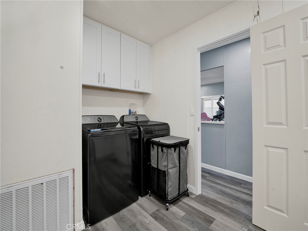 24303 Woolsey Canyon Road, Unit 85 West Hills, CA 91304 - Photo 20 of 31 a view of a storage & utility room with closet wooden floor and windows