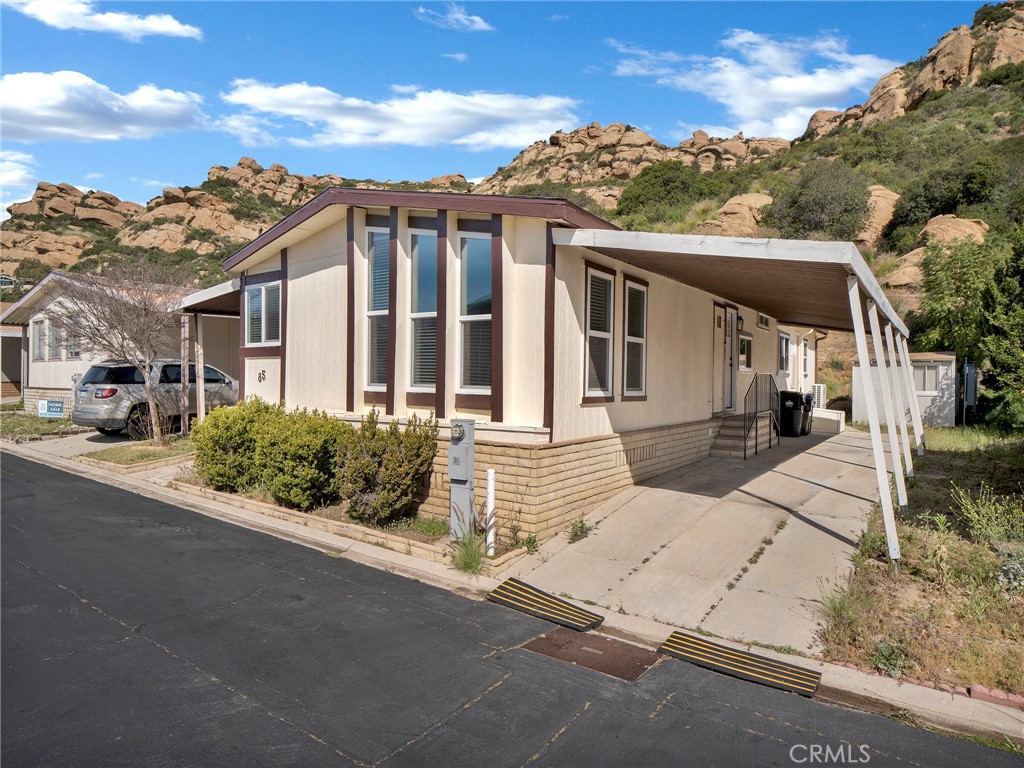24303 Woolsey Canyon Road, Unit 85 West Hills, CA 91304 - Photo 24 of 31 front view of a house with a street