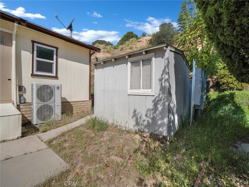 24303 Woolsey Canyon Road, Unit 85 West Hills, CA 91304 - Photo 26 of 31 a front view of a house with garden