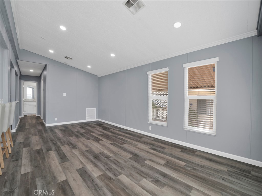 24303 Woolsey Canyon Road, Unit 85 West Hills, CA 91304 - Photo 4 of 31 a view of an empty room with wooden floor and a window