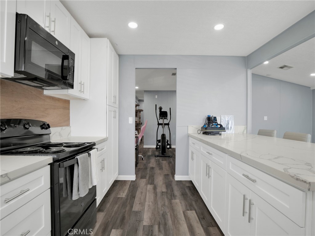 24303 Woolsey Canyon Road, Unit 85 West Hills, CA 91304 - Photo 7 of 31 a kitchen with a sink stove and microwave