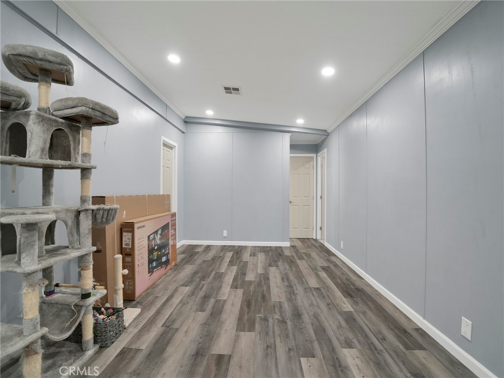 24303 Woolsey Canyon Road, Unit 85 West Hills, CA 91304 - Photo 10 of 31 a view of empty room with wooden floor
