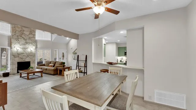 a living room with furniture a fireplace and a chandelier