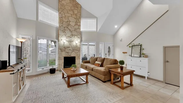 a living room with furniture a fireplace and a flat screen tv