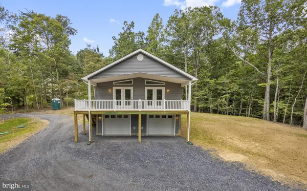 a view of a house with a yard and sitting area