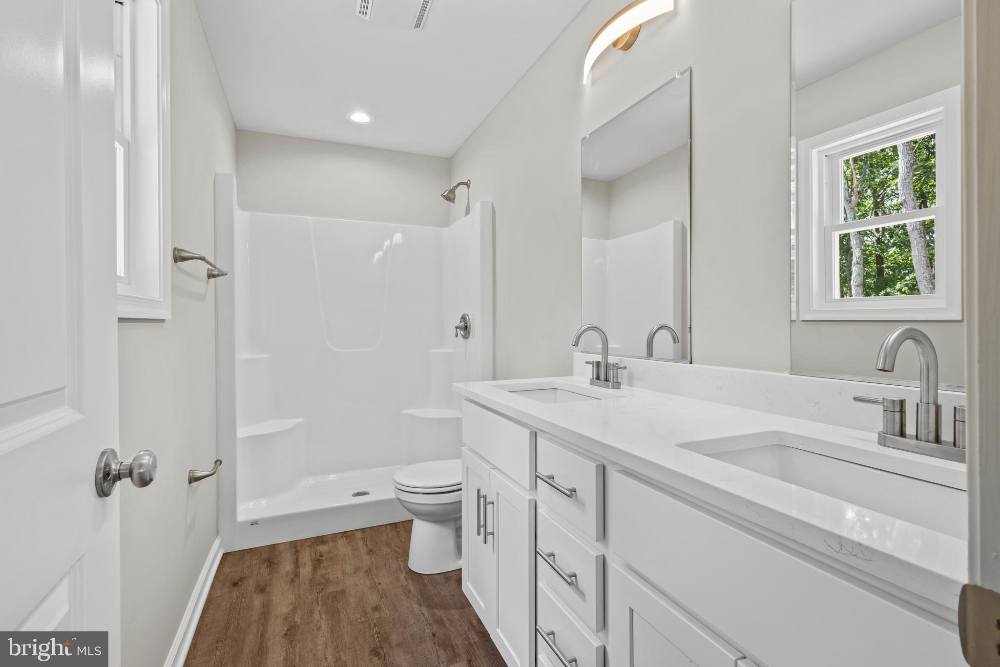 172 Martins Farm Road Front Royal, VA 22630 - Photo 11 of 22 a bathroom with a granite countertop sink a toilet and shower