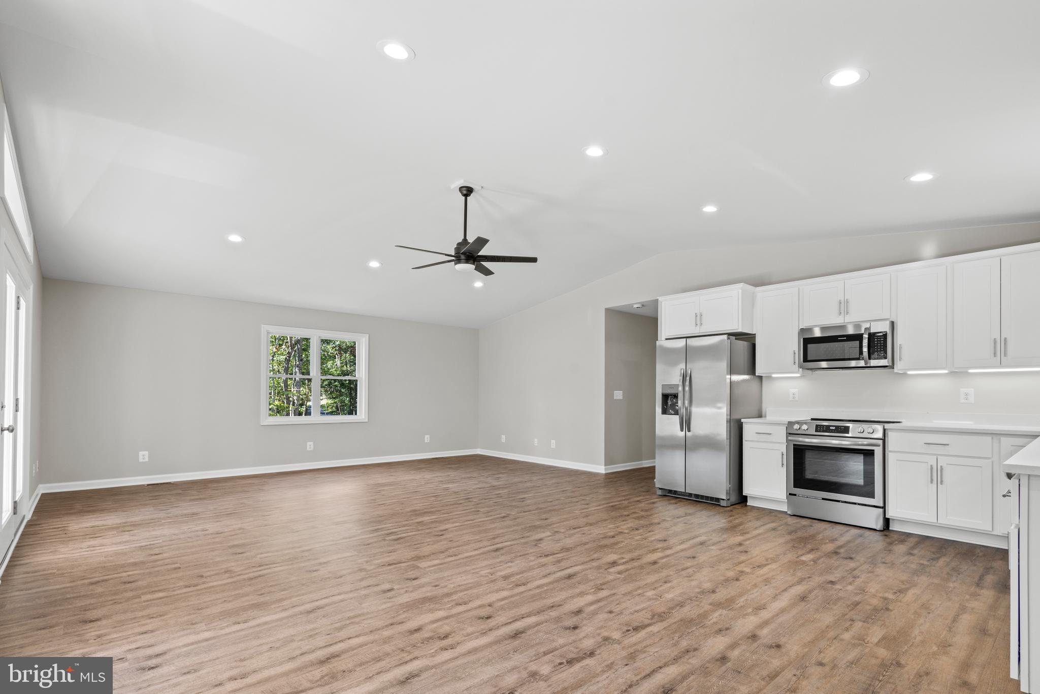 172 Martins Farm Road Front Royal, VA 22630 - Photo 3 of 22 a view of kitchen with stainless steel appliances refrigerator stove microwave and cabinets