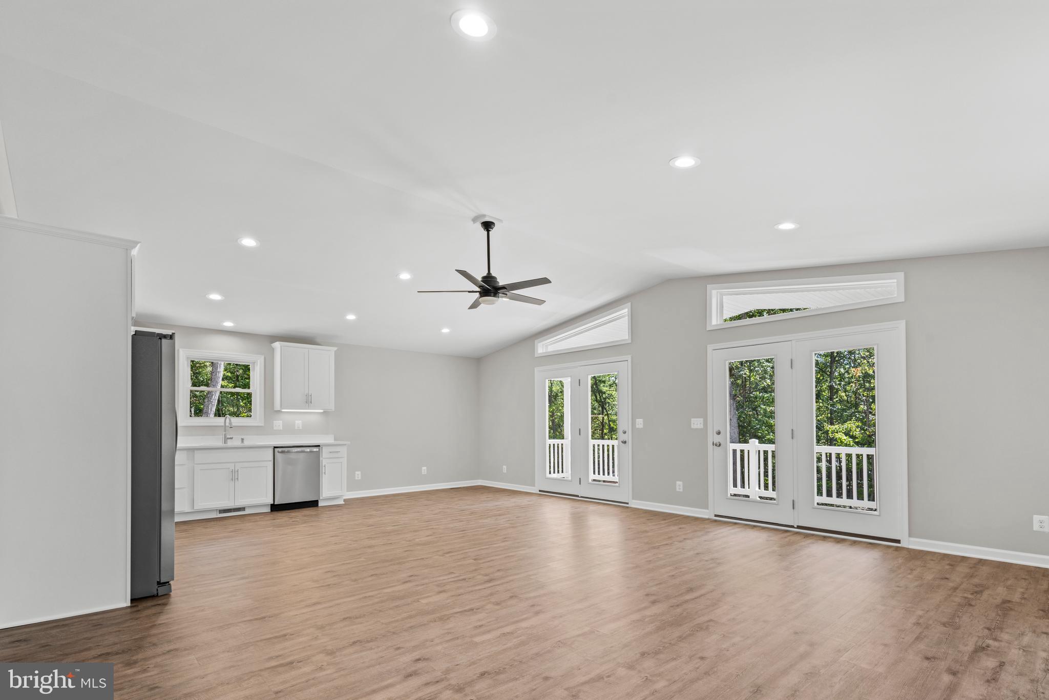 172 Martins Farm Road Front Royal, VA 22630 - Photo 4 of 22 a view of an empty room with a window and wooden floor