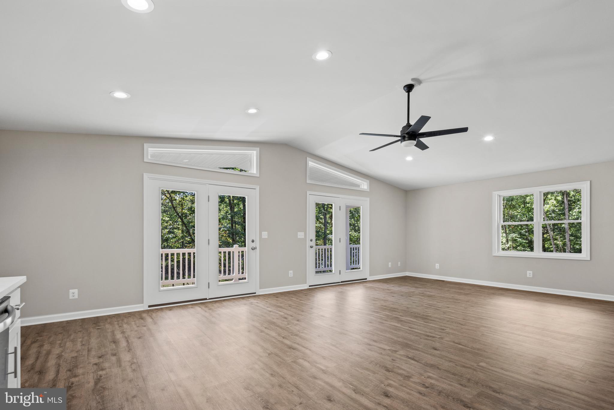 172 Martins Farm Road Front Royal, VA 22630 - Photo 5 of 22 a view of an empty room with a window and wooden floor