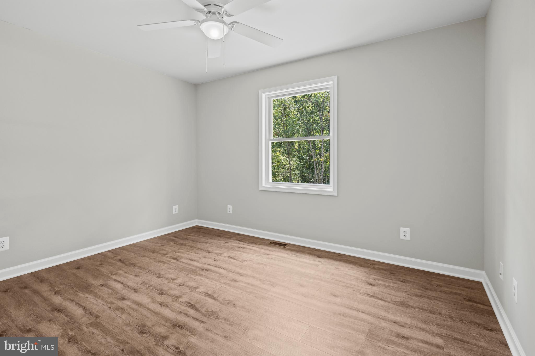 172 Martins Farm Road Front Royal, VA 22630 - Photo 9 of 22 an empty room with wooden floor and windows