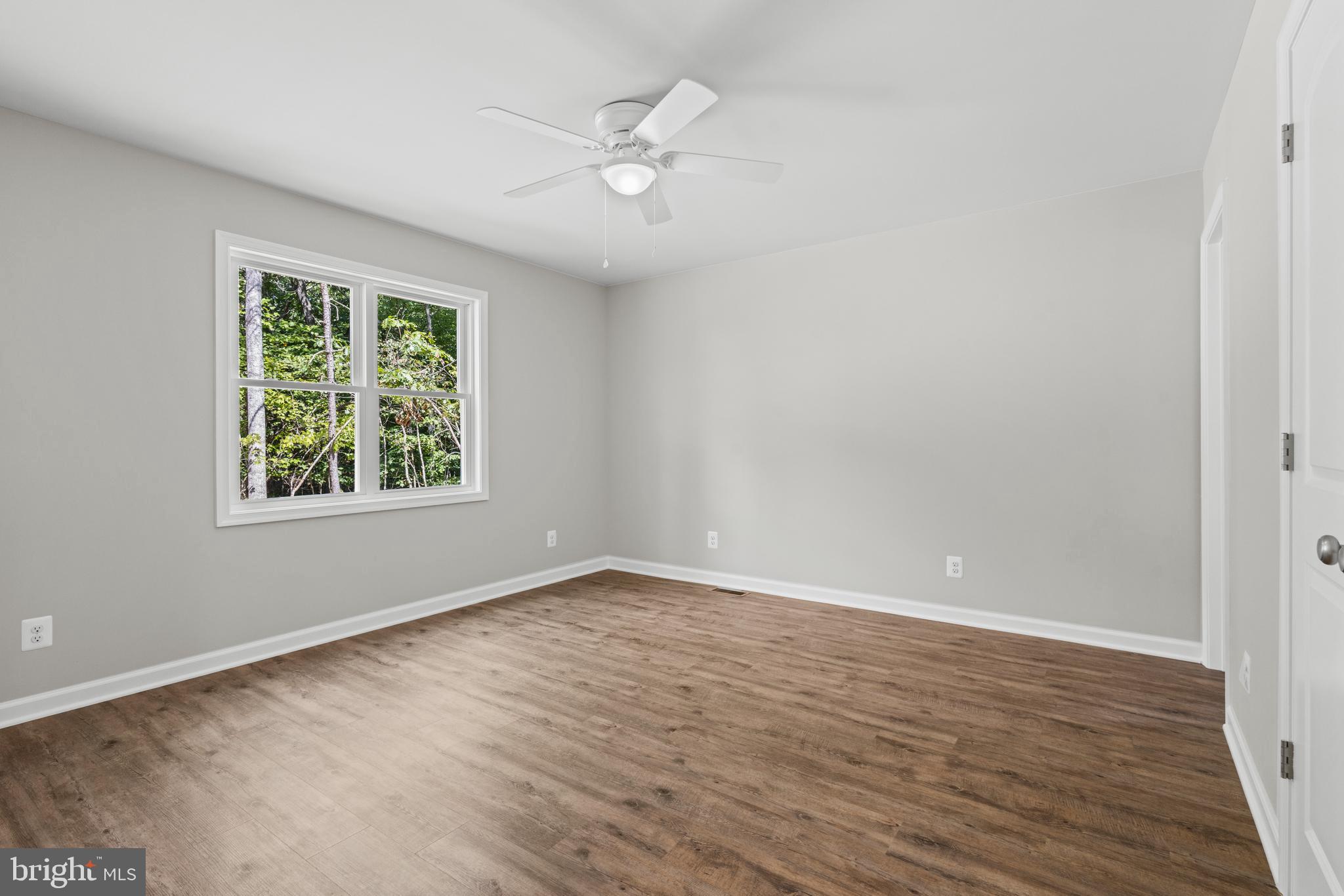 172 Martins Farm Road Front Royal, VA 22630 - Photo 10 of 22 a view of an empty room with wooden floor and a window