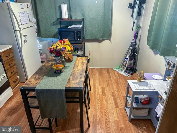 a dining room with furniture and wooden floor