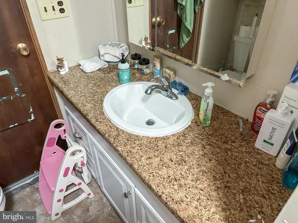 a bathroom with a sink and mirror