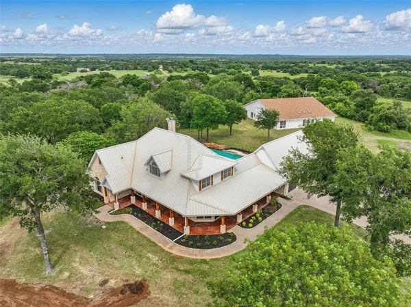 a aerial view of a house with a yard and a garden