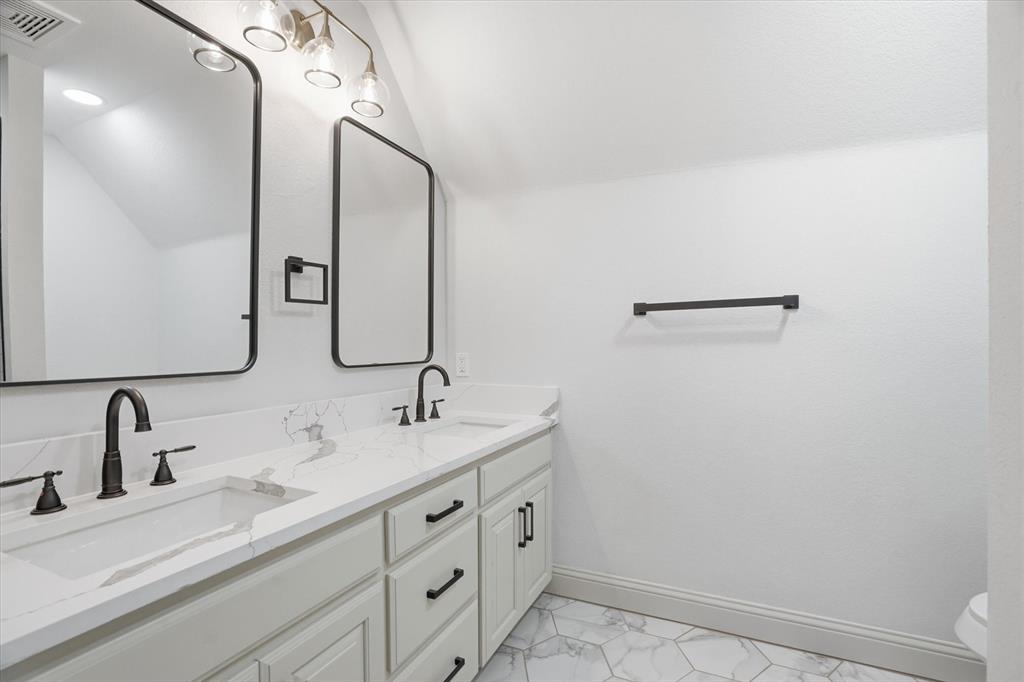 1430 Black Hawk Trail Nemo, TX 76070 - Photo 22 of 40 a bathroom with a double vanity sink and mirror