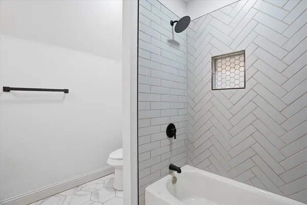 a bathroom with a tub and a shower