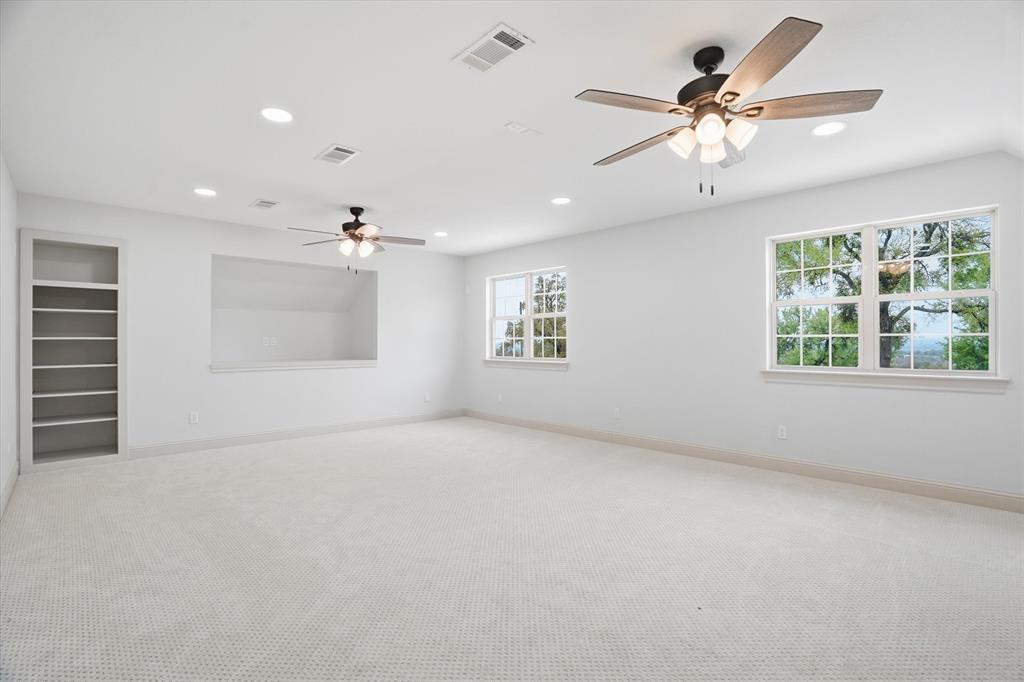 1430 Black Hawk Trail Nemo, TX 76070 - Photo 25 of 40 an empty room with windows and ceiling fan