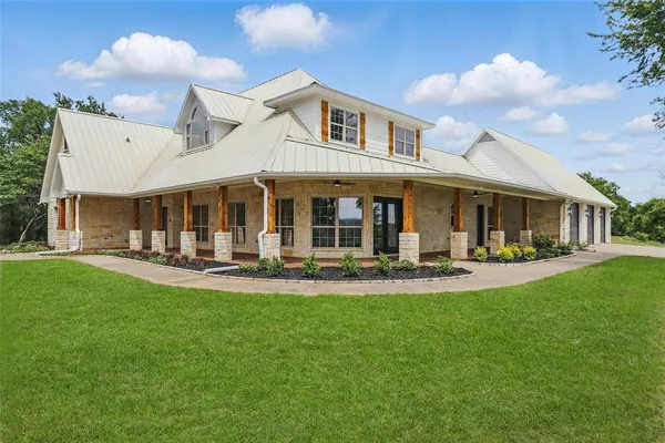 a view of a house with a yard patio and swimming pool