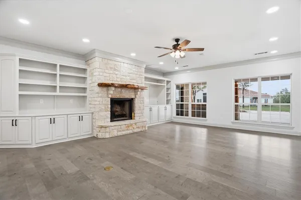 a view of an empty room with a fireplace and a window