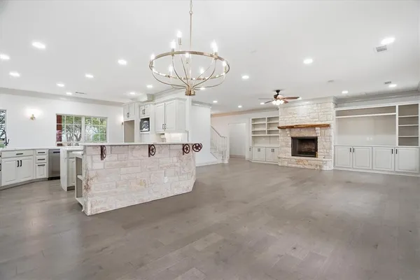 a large white kitchen with a white stove top oven and cabinets