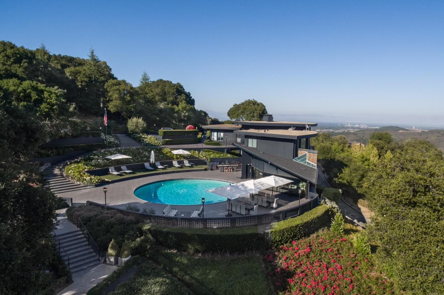 a view of a swimming pool with a yard and plants