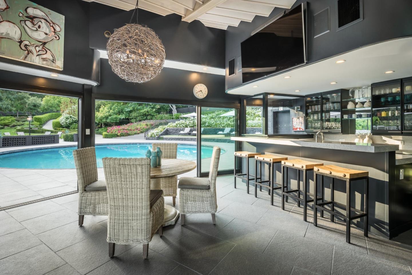 835 La Honda Road Woodside, CA 94062 - Photo 12 of 30 a dining room with furniture a floor to ceiling window and outdoor view
