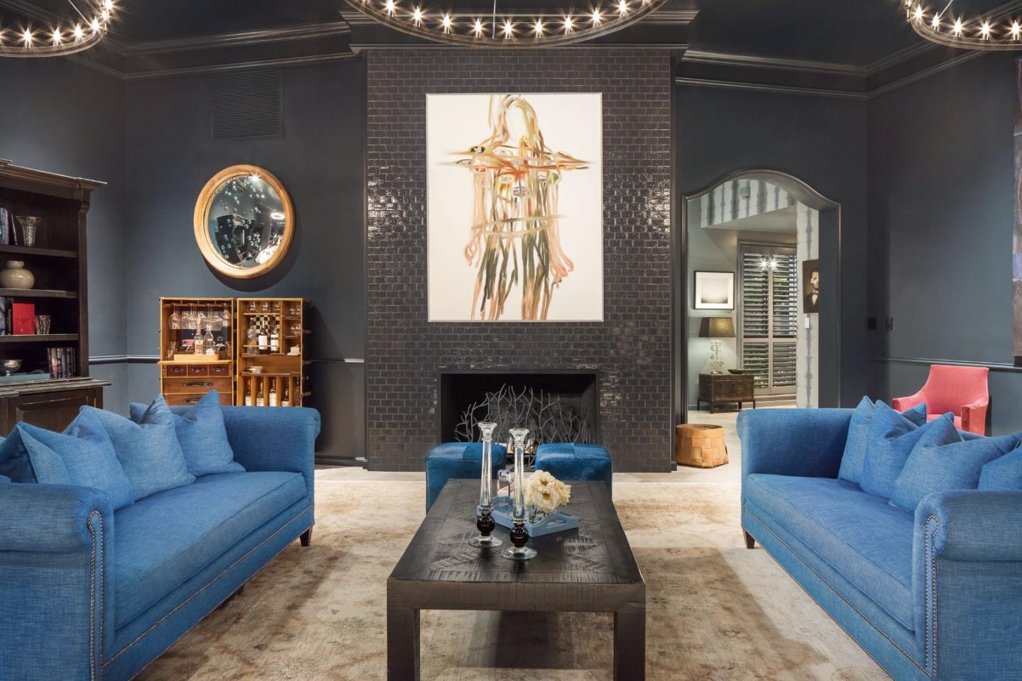 835 La Honda Road Woodside, CA 94062 - Photo 17 of 30 a living room with furniture a clock and a fireplace