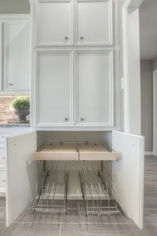 a view of a hallway with cabinet and a window