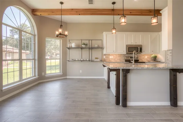 a view of a livingroom with wooden floor and a fireplace