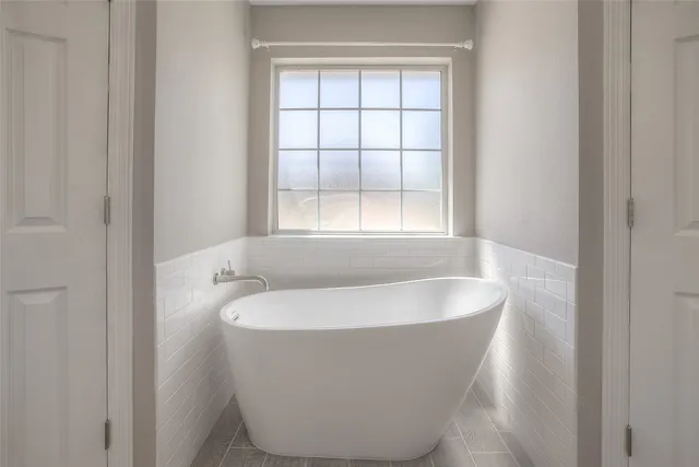 a bathroom with a granite countertop sink a shower and a mirror